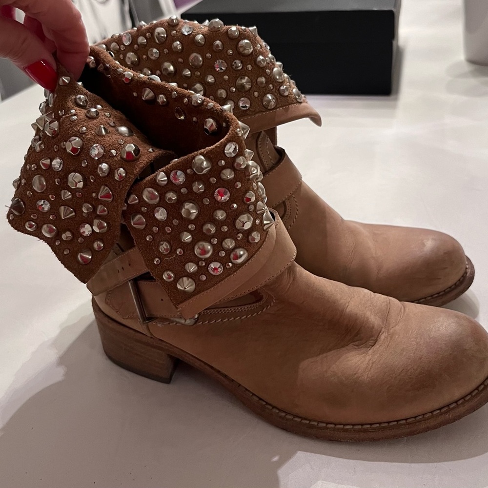 Ankle boots with studded flaps.